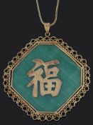 A large Chinese green hardstone character pendant on chain