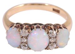 An attractive Edwardian three stone opal and diamond set ring