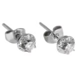 A pair of delicate single stone diamond stud earrings