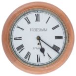 An early 20th century light oak cased dial wall clock