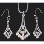 A Continental diamond set scroll pendant with matching earrings