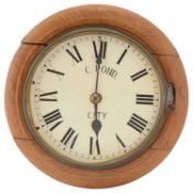 An early 20th century small light oak cased dial wall clock