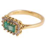 A delicate rectangular cut emerald and diamond cluster ring