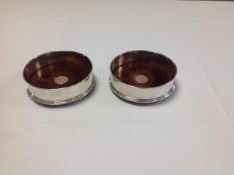 A pair of contemporary silver bottle coasters