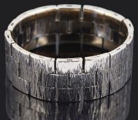 A white metal textured articulated brick link ring