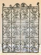 A pair of early 20th century black painted wrought iron garden gates