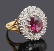 A large pink gem and diamond set oval cluster ring