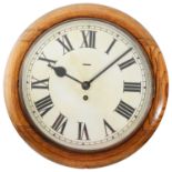An early 20th century Smiths oak framed dial wall clock