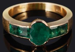 An unusual, attractive calibre set emerald ring