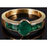 An unusual, attractive calibre set emerald ring