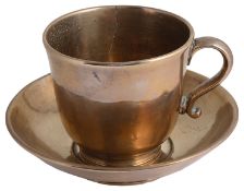 An unusual 19th century large polished bronze tea cup and saucer