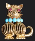 An amusing ruby and turquoise set cat cocktail brooch, circa 1950