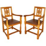 A pair of Wilf 'Squirrelman' Hutchinson oak elbow chairs
