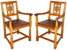 A pair of Wilf 'Squirrelman' Hutchinson oak elbow chairs