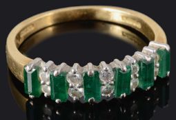 A contemporary emerald and diamond half eternity ring