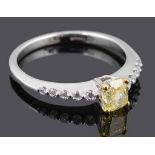 A delicate natural fancy intense yellow diamond set ring