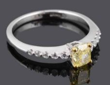 A delicate natural fancy intense yellow diamond set ring