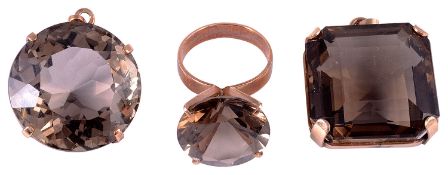 A large Continental smoky quartz set dress ring and two similar pendants