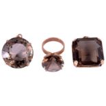 A large Continental smoky quartz set dress ring and two similar pendants