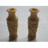 PAIR OF HEAVILY CARVED ANTIQUE IVORY VASES DECORATED WITH CHINESE DRAGONS,