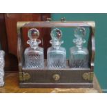 BRASS MOUNTED THREE DECANTER TANTALUS