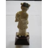 ANTIQUE ORIENTAL IVORY CARVING OF A YOUNG GIRL ON WOODEN STAND,