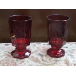 PAIR OF EARLY VICTORIAN RUBY COLOURED OCTAGONAL STEMMED GLASSES (AT FAULT),