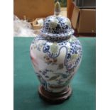 HANDPAINTED AND GILDED ORIENTAL CERAMIC GINGER JAR WITH COVER ON WOODEN STAND,