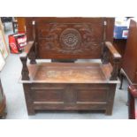 CARVED FRONTED OAK MONK'S BENCH WITH LIFT UP SEAT