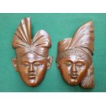 PAIR OF CARVED TREEN MALAYAN WALL MASKS