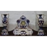VICTORIAN CERAMIC MANTLE CLOCK ON STAND AND MATCHING VASES ON STANDS,