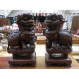 PAIR OF HEAVILY CARVED ORIENTAL TREEN MYTHICAL DOGS OF FO,