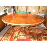 ANTIQUE FIGURED WALNUT VENEERED OVAL BREAKFAST TABLE ON QUAD SUPPORTS