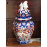 HANDPAINTED ORIENTAL STYLE HEXAGONAL STORAGE JAR WITH COVER, IN THE IMARI PALETTE,