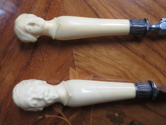 CASED PAIR OF HEAVILY CARVED BONE/IVORY HANDLED CARVING SET DEPICTING A CLASSICAL LADY AND GENT, - Image 2 of 2