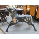 BLACK LACQUERED AND LEATHER MOUNTED CHILD'S MODEL HORSE DEPICTING NURSERY RHYME SCENES