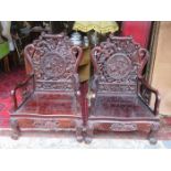 HEAVILY CARVED HARDWOOD THRONES DECORATED IN THE ORIENTAL MANNER