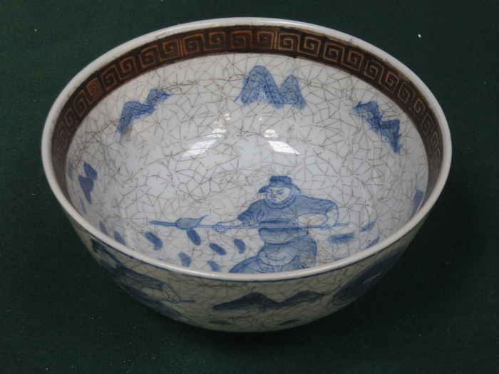 BLUE AND WHITE CRACKLE GLAZED POTTERY BOWL, DECORATED WITH AN ORIENTAL SOLDIER,