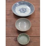 ORIENTAL BLUE AND WHITE GLAZED CERAMIC BOWL AND TWO CELADON TYPE CERAMIC SHALLOW BOWLS