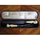 CASED PAIR OF HEAVILY CARVED BONE/IVORY HANDLED CARVING SET DEPICTING A CLASSICAL LADY AND GENT,