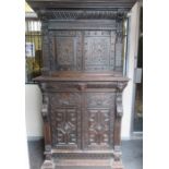 HEAVILY CARVED DARK OAK STORAGE CABINET FITTED INSIDE WITH DRAWERS