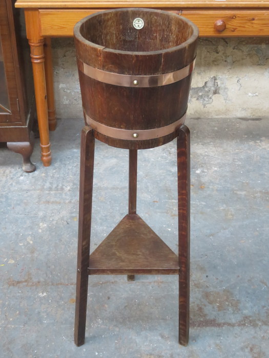 OAK COPPER BOUND BARREL FORM PLANT STAND ON TRI-SUPPORTS WITH MAKER'S LABEL RA LISTER & CO LTD,