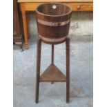 OAK COPPER BOUND BARREL FORM PLANT STAND ON TRI-SUPPORTS WITH MAKER'S LABEL RA LISTER & CO LTD,