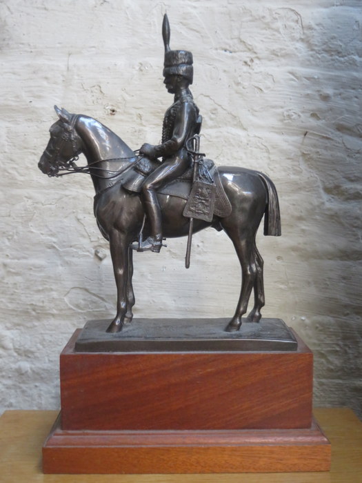 BRONZE EFFECT FIGURE OF A MILITARY GENT ON HORSEBACK, MOUNTED ON WOODEN PLINTH,