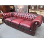 OX BLOOD RED UPHOLSTERED LEATHER THREE SEATER SETTEE