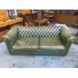GREEN COLOURED UPHOLSTERED TWO SEATER SETTEE