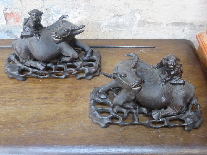 PAIR OF ORIENTAL CARVED HARDWOOD WATER BUFFALO FIGURES,