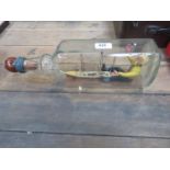 DECORATIVE MODEL OF A SHIP IN A BOTTLE WITH INFORMATION ON THE UNDERSIDE