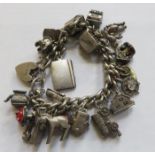 SILVER CHARM BRACELET WITH APPROXIMATELY TWENTY CHARMS