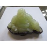 CHINESE JADE CARVED BUDDHA UPON SHAPED HARDWOOD STAND,